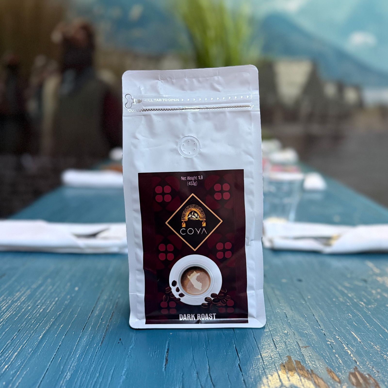 Coya Peruvian coffee, dark roast, on a blue table